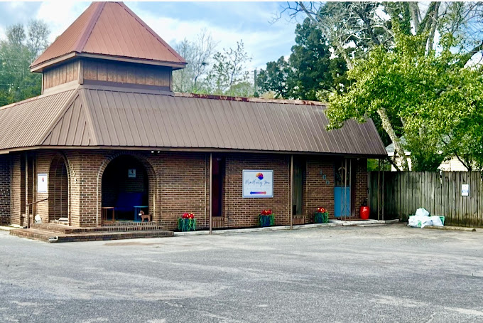 The brick building housing the SeaChange Mental Health Crestview office, with a covered entrance and the Mindfully You Therapy Services sign by the door